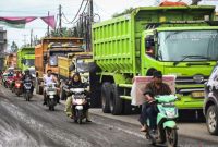 Arsip - Sejumlah pengendara motor melintas di samping sejumlah truk yang mengantre di kawasan Parung Panjang, Kabupaten Bogor, Jawa Barat, Kamis (19/12/2024). ANTARA FOTO/Sulthony Hasanuddin/foc